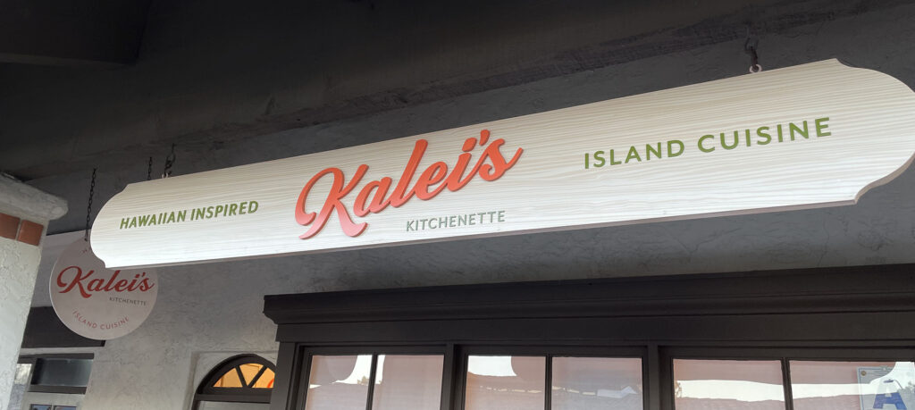 Long sign hanging on the exterior of Kalei's Kitchenette restaurant.
